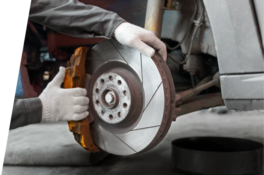 photo of a car service technician performing a brake repair service