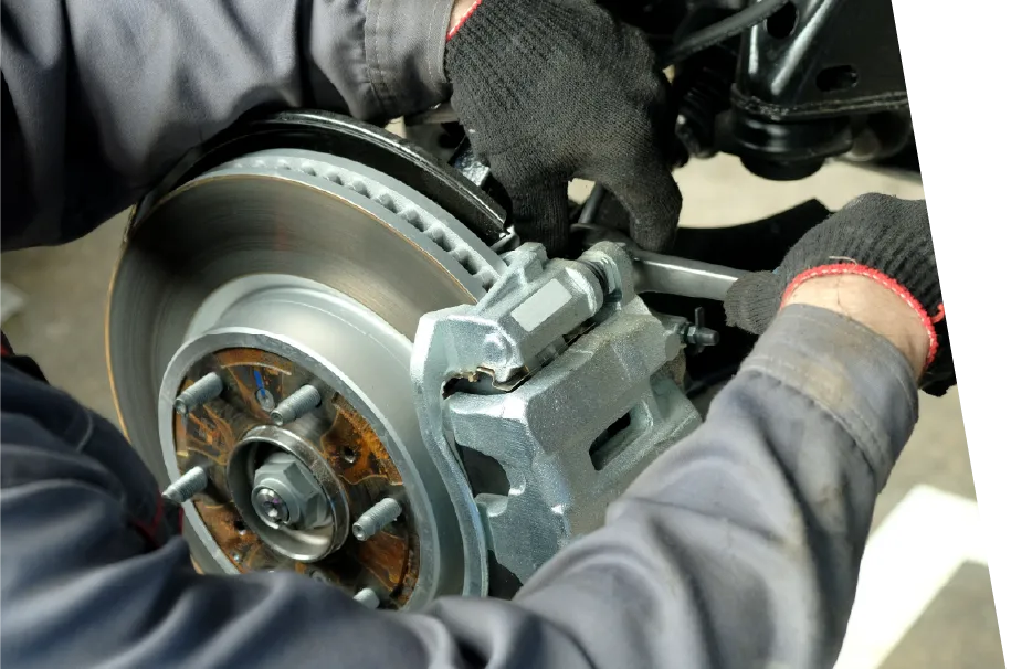 photo of a car service technician performing a brake repair service
