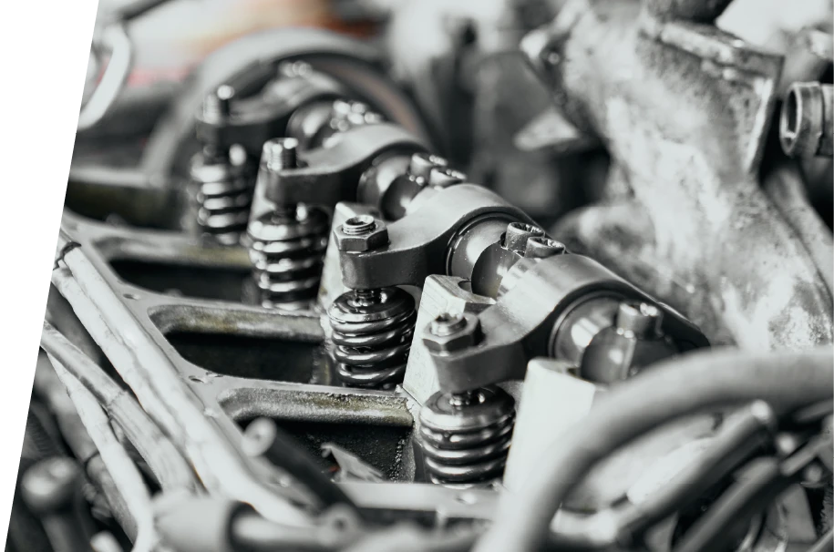 photo of the top of an car motor being inspected after engine maintenance