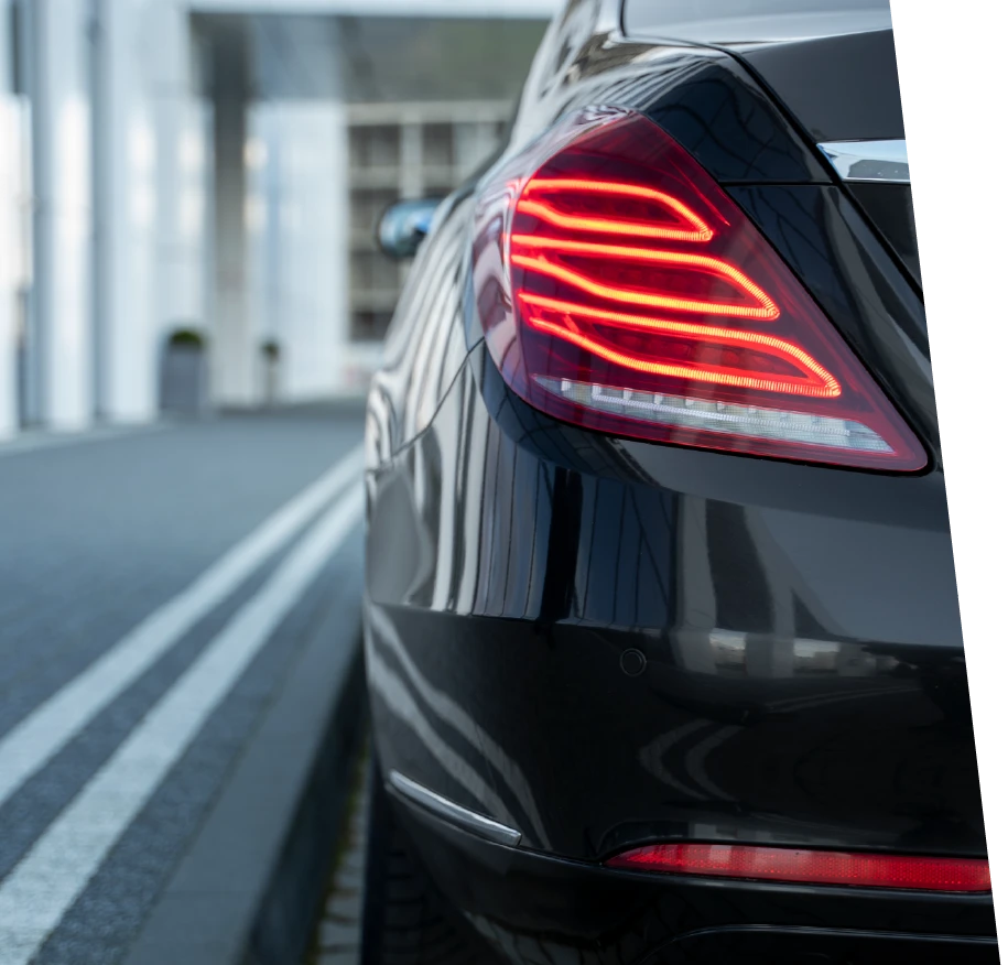 photo of a black loaner car with red tail lights 