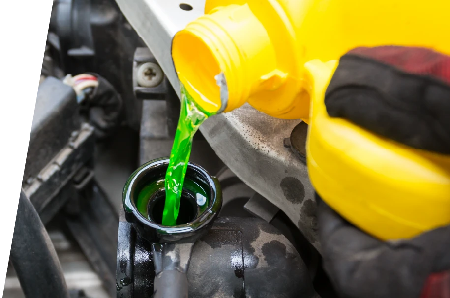photo of green coolant being added to a car during a synthetic oil change