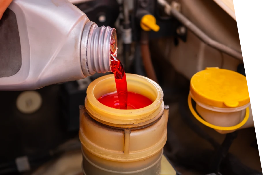 photo of red brake fluid added to a car during a synthetic oil change