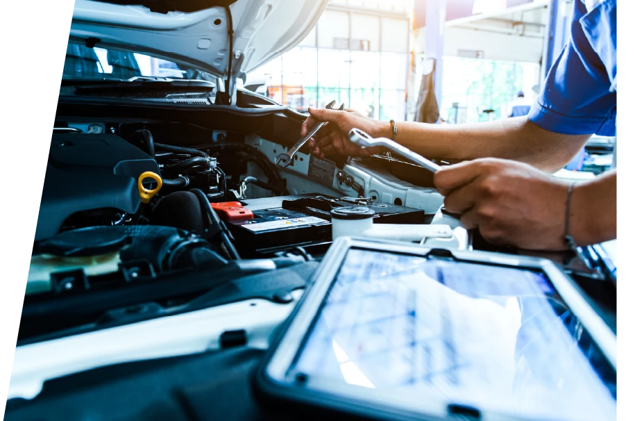 photo of a vehicle technician with wrenches performing a car tune up