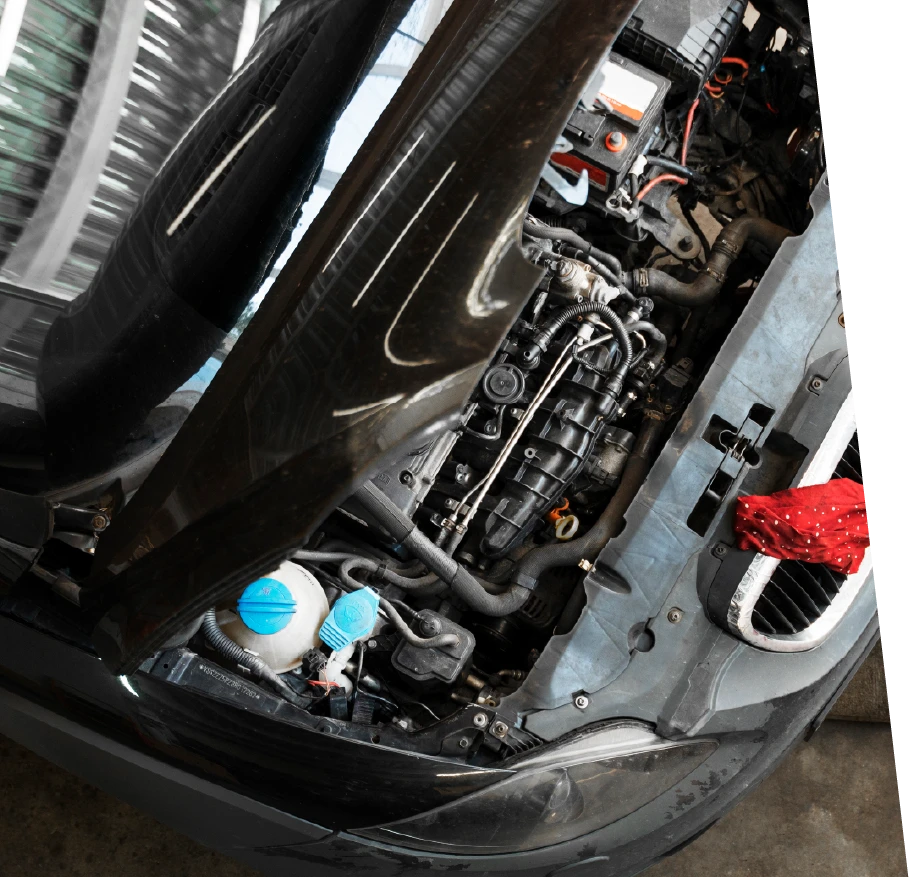 photo of a vehicle with an open hood, being prepped for a car tune up