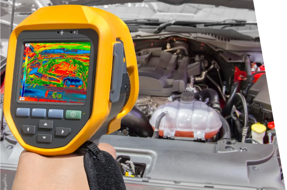 photo of a service technician using an infrared heat gun to measure temperature for car diagnostics