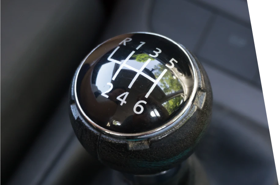 closeup photo of a manual transmission gear shifter knob prior to transmission repair