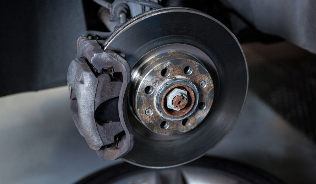 photo of car brakes and rotor during a brake fluid maintenance
