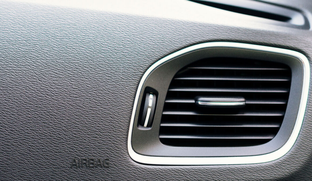 photo of an air vent in a car blowing through a cabin air filter