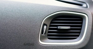 photo of an air vent in a car blowing through a cabin air filter
