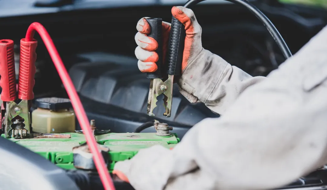 photo of a technician testing a car battery before car battery maintenance
