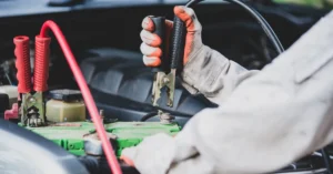 photo of a technician testing a car battery before car battery maintenance